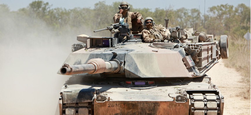 U.S. Marines with Alpha Company, 1st Tank Battalion, 1st Marine Division ride in an M1A1 Abrams tank during an exercise in 2013.