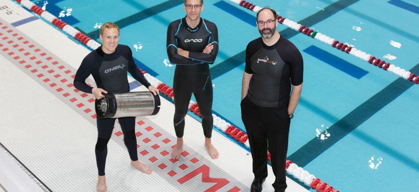 From left, graduate student Anton Cottrill, Dr. Jacopo Buongiorno and Dr. Michael Strano try out neoprene wetsuits at MIT’s athletic center. 