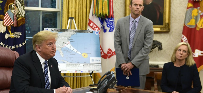 Reporters question FEMA Administrator Brock Long (center) during a briefing on Hurricane Florence Tuesday. 