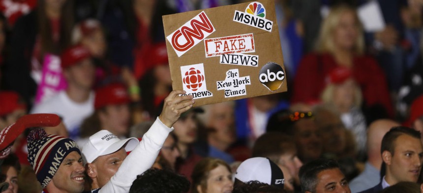 An audience member holds a fake news sign during a President Donald Trump campaign rally in Michigan on April 28.