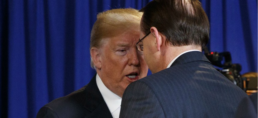 President Trump shakes hands with Deputy Attorney General Rod Rosenstein after a roundtable on immigration policy in May.