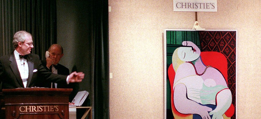 Picasso's "The Dream" is auctioned by auctioneer Christopher Burge at Christie's auction house in New York in 1997.