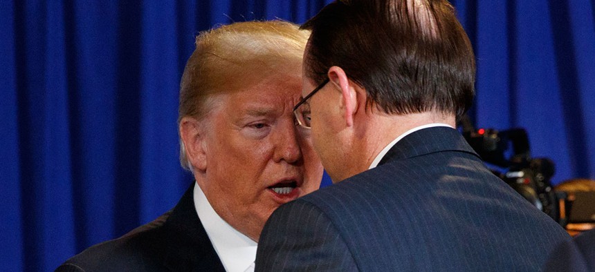 President Donald Trump shakes hands with Deputy Attorney General Rod Rosenstein after a roundtable on immigration policy at Morrelly Homeland Security Center in May.