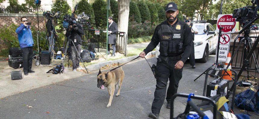 A Secret Service officer and his dog search for bombs at a checkpoint near former President Obama's home in Washington on Wednesday. Obama was one of the officials targeted with the explosive devices. 