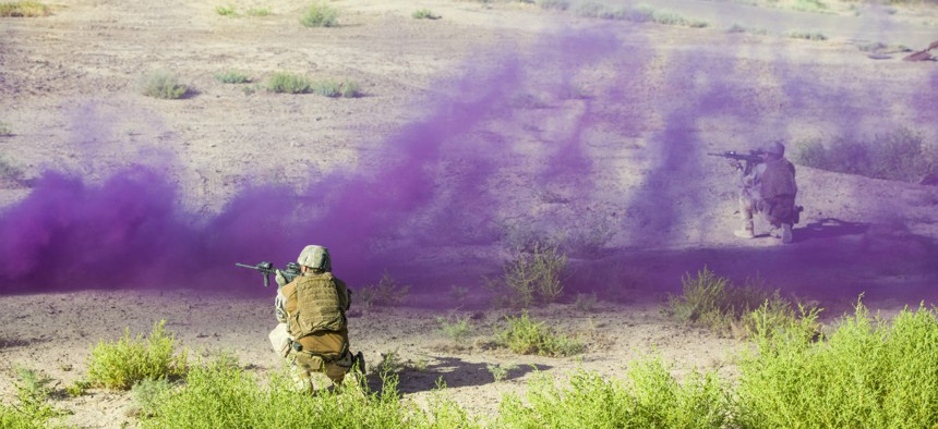Combined forces participate in a live fire exercise at Camp Taji, Iraq, in August. 