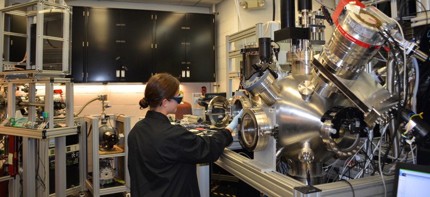 Ashley Wissel, Purdue University undergraduate student, works with the pulsed laser deposition chamber in the Materials and Manufacturing Directorate. This is used to study growth of thin layers of material at low temperatures.