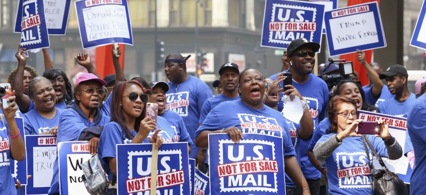 Postal workers and their supporters rally in Chicago on Oct. 8, 2018, to protest a proposal announced in June by the White House to privatize the U.S. Postal Service.