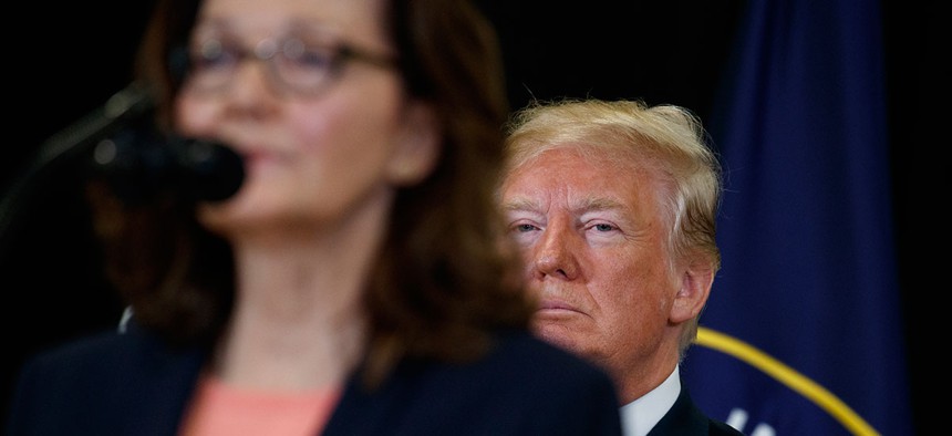 President Donald Trump listens as incoming Central Intelligence Agency director Gina Haspel speaks during a swearing-in ceremony at CIA Headquarters in May.