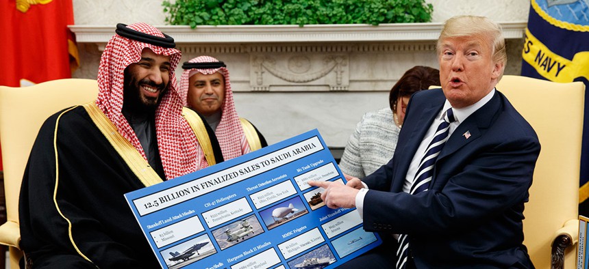 President Donald Trump shows a chart highlighting arms sales to Saudi Arabia during a meeting with Saudi Crown Prince Mohammed bin Salman in the Oval Office in March.