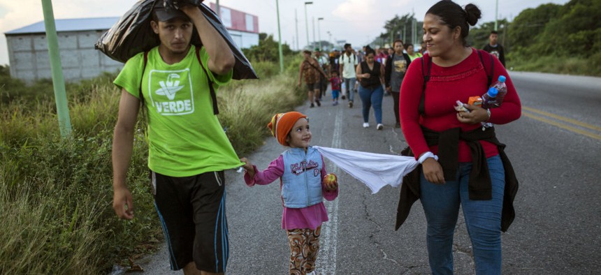 Honduran migrants walk through Mexico toward the U.S. border with their 4-year-old daughter. 