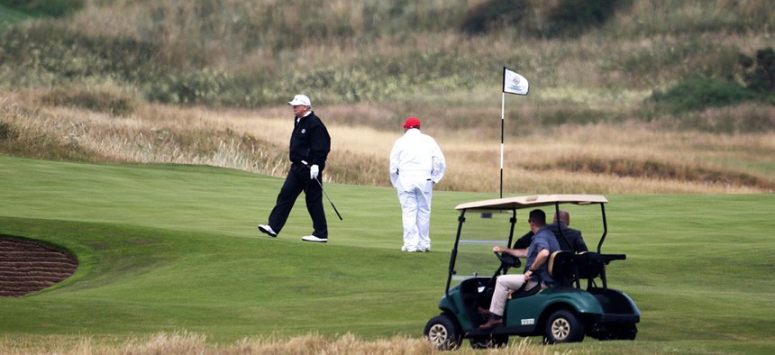 Donald Trump walks off the 4th green while playing at Turnberry golf club in Scotland in July.