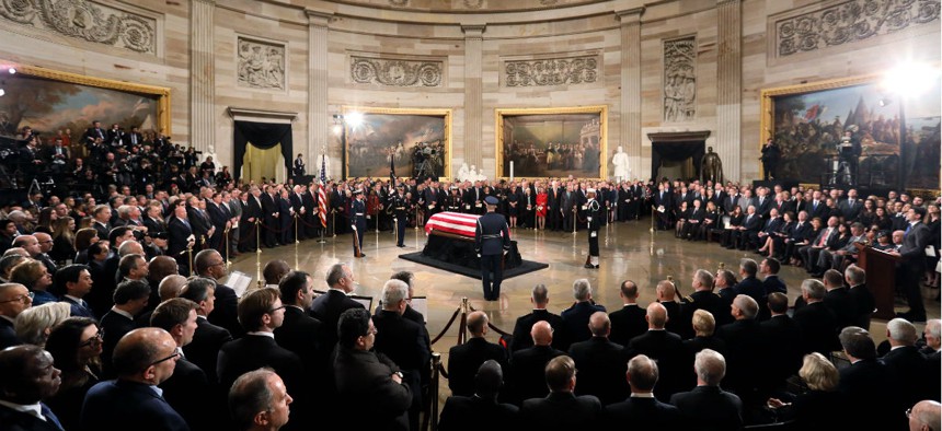 The flag-draped casket of former President George H.W. Bush lies in state in the Capitol Rotunda in Washington, Monday, Dec. 3, 2018.