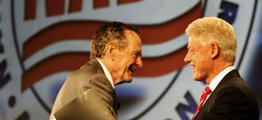Former Presidents George H. W. Bush and Bill Clinton greet each other in New Orleans in 2009.