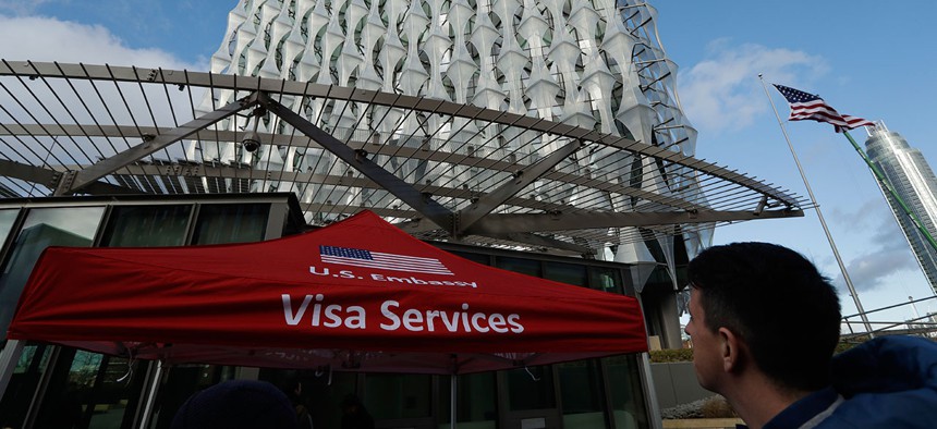 A Visa Services gazebo stands outside as the first group of Visa applicants to go into the new United States Embassy building in London, wait in line outside, Tuesday, Jan. 16, 2018.