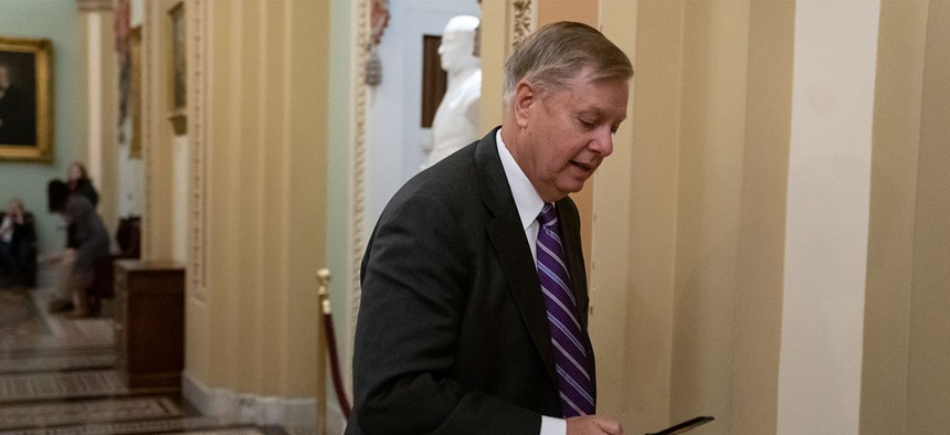 Sen. Lindsey Graham, R-S.C., rushes to the office of Senate Majority Leader Mitch McConnell, R-Ky., on Dec. 19, 2018. Graham called Trump's apparent decision to withdraw all U.S. troops from Syria "a disaster in the making."