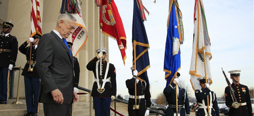 Defense Secretary Jim Mattis walks down the steps of the Pentagon on Wednesday, Dec. 19.