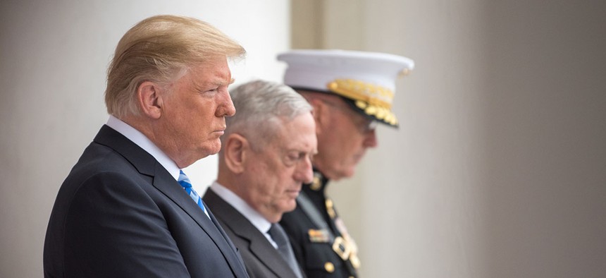 Donald J. Trump, Secretary of Defense James N. Mattis and Chairman of the Joint Chiefs of Staff Marine Gen. Joseph F. Dunford Jr., bow their heads during a Memorial Day ceremony in May.