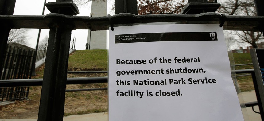 A sign is posted on a fence near an entrance to the Bunker Hill Monument Monday.
