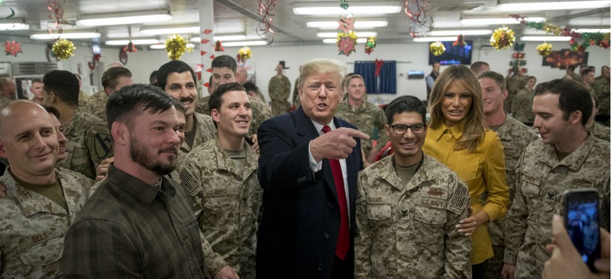 President Trump and first lady Melania Trump pose for a photograph as they visit members of the military at Al Asad Air Base, Iraq, Dec. 26, in a surprise trip to Iraq.