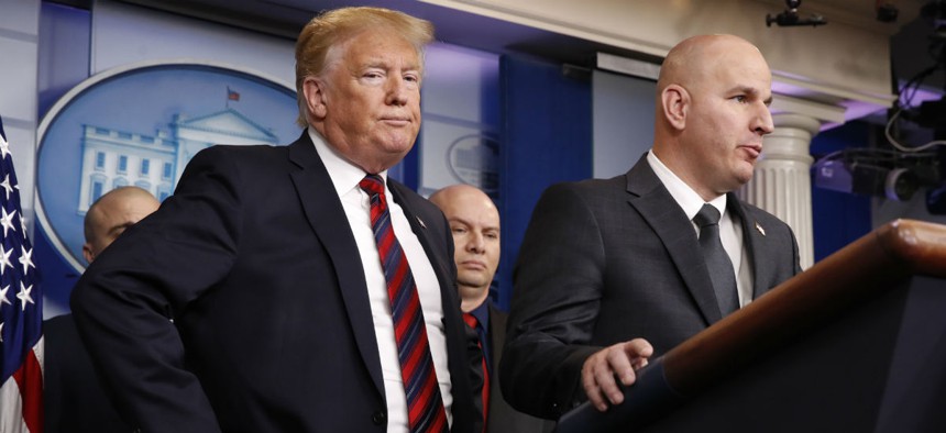 President Trump listens as Brandon Judd, president of the National Border Patrol Council, speaks at a press conference Thursday. 
