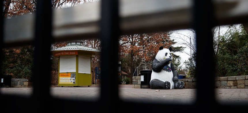 A panda statue is seen beyond the closed gate at Smithsonian's National Zoo, Wednesday, Jan. 2, 2019.