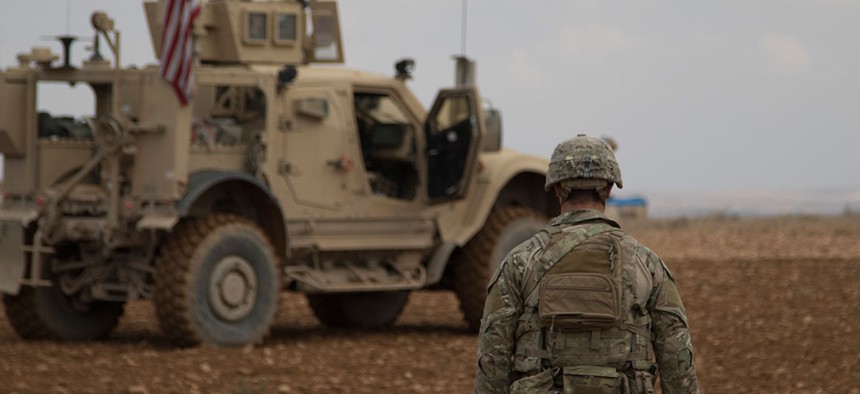 A soldier walks toward a tactical vehicle after completing a successful combined joint patrol rehearsal in Manbij, Syria in November.