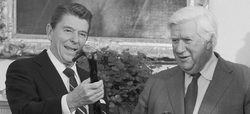 President Ronald Reagan and House Speaker Thomas P. O'Neill of Mass., share a laugh as they are presented a pair of walking sticks at the White House, Dec. 10, 1981. 