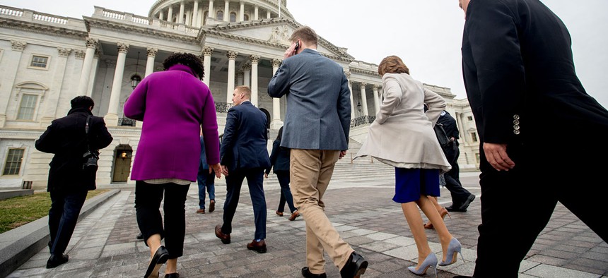 Members of Congress, including House Speaker Nancy Pelosi of Calif., second from right, walk toward the Capitol building, Jan. 4, 2019.