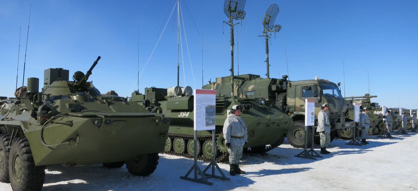 In this photo taken on Tuesday, April 25, 2017, soldiers of the Arctic motorised rifle brigade of Russia's Northern Fleet took stand near APCs during military exercise in Alakyrtti, Murmansk region, Russia.