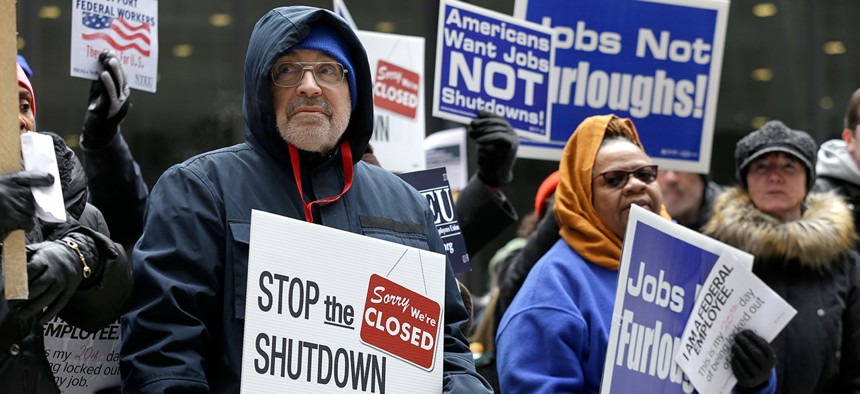 Government workers rally against the partial government shutdown at Federal Plaza on Thursday in Chicago.