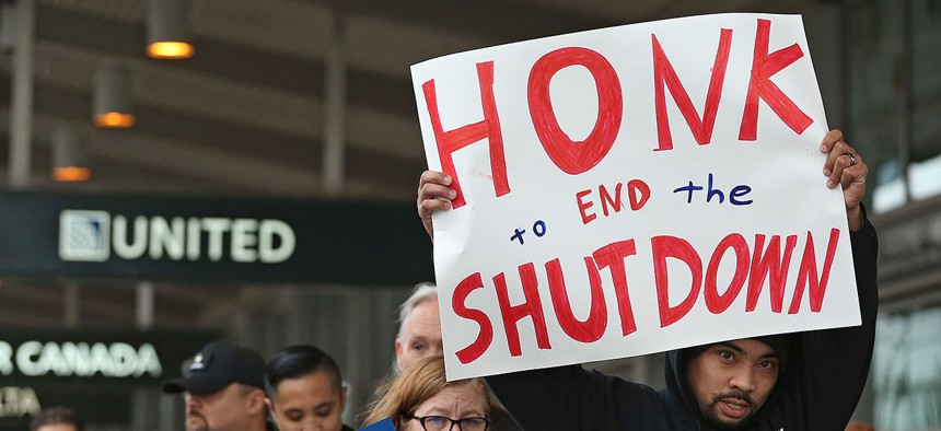 More than two dozen federal employees and supporters demonstrated at the Sacramento International Airport on Wednesday.