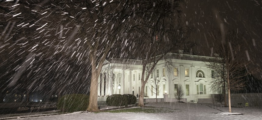 Snow falls at the White House on Thursday.