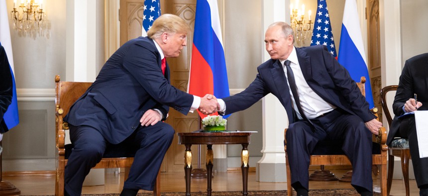 President Donald Trump shakes hands with Russian President Vladimir Putin in July.
