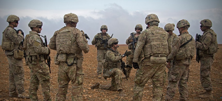 U.S. Soldiers gather for a brief during a combined joint patrol rehearsal in Manbij, Syria, in November.