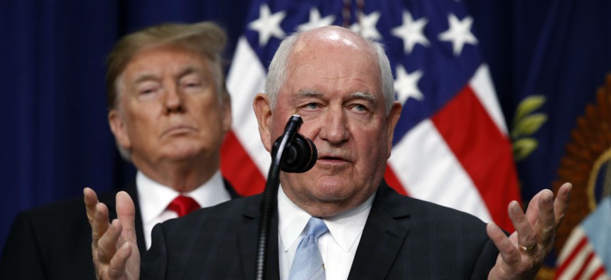 President Trump listens to Agriculture Secretary Sonny Perdue during a signing ceremony for the 2018 farm bill in December.