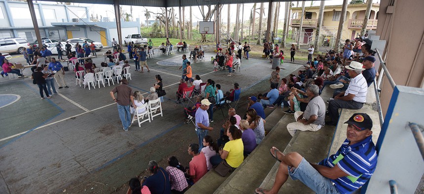 People gather at the Jose de Diego Elementary School to file FEMA forms for federal aid in the aftermath of Hurricane Maria in Las Piedras in Oct. 2017.