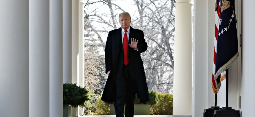 President Trump waves as he walks from the Oval Office to announce a deal to temporarily reopen the government on Jan. 25.