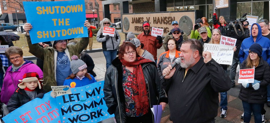 People gather during a federal workers protest rally in Ogden, Utah on Jan. 10.