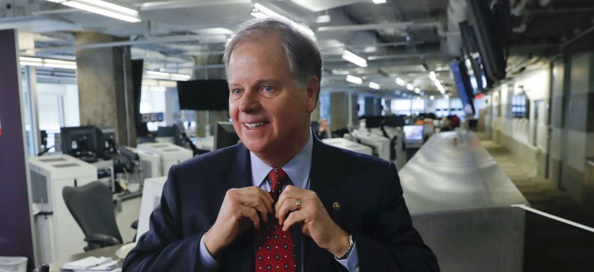 Sen. Doug Jones, D-Ala., says federal workers should be paid interest on wages delayed during the shutdown. 