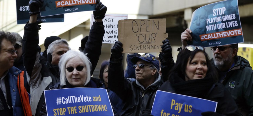 Union and labor supporters demonstrate at a rally by federal workers at the Philadelphia International Airport to end the government shutdown on Friday, Jan. 25.