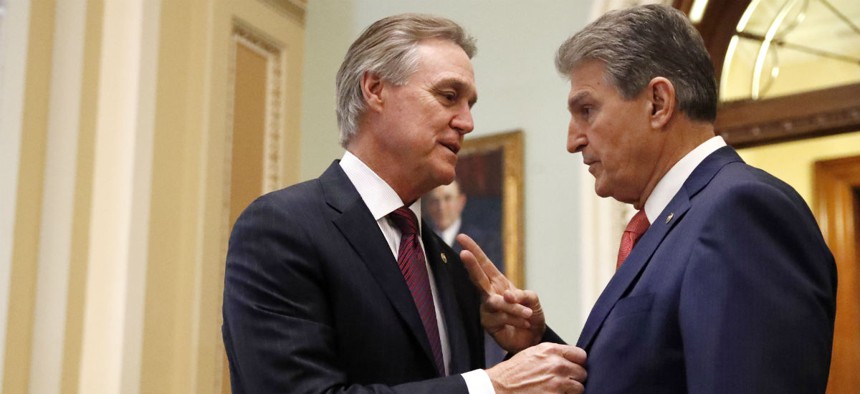 Senators David Perdue, R-Ga., left, and Joe Manchin, D-W.Va., are among the bipartisan group that have expressed concern about the Pentagon's ability to improve financial management.