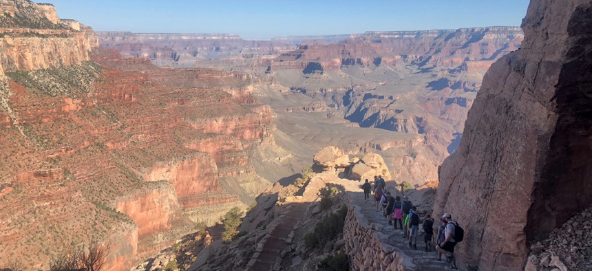 Hikers walk along the South Rim of the Grand Canyon in 2018.