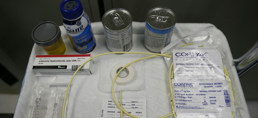 Nutritional shakes, a tube for feeding through the nose, and lubricants, including a jar of olive oil, are displayed as force feeding is explained during a tour of the detainee hospital at Guantanamo Bay Naval Base, Cuba in 2013.