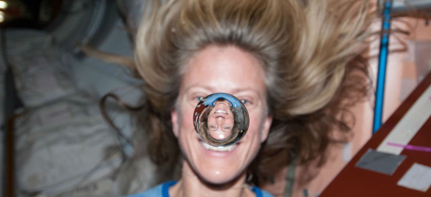 NASA astronaut Karen Nyberg poses with a water bubble on the International Space Station