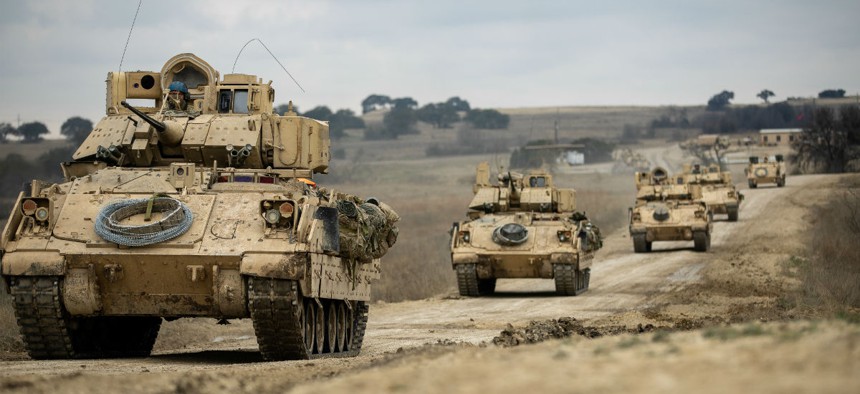 Bradley Fighting Vehicles convoy towards their battle positions during the combined arms live-fire exercise Feb. 9.