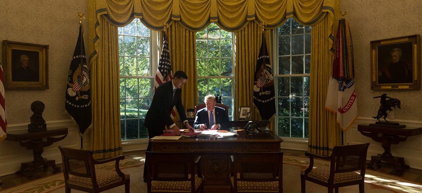 Trump works in the Oval Office in 2017