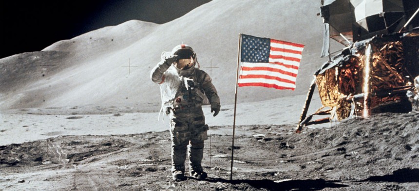 Astronaut David R. Scott, commander, gives a military salute while standing beside the deployed United States flag during the Apollo 15 lunar surface extravehicular activity in 1971.