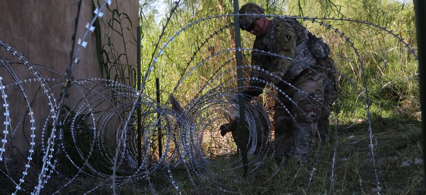   Soldiers deploy concertina wire in a location along the Southwest border of the United States near Hidalgo, Texas in November.