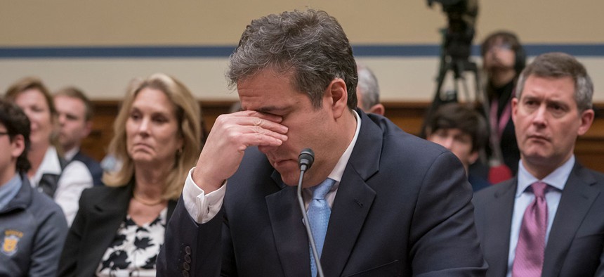 Michael Cohen, President Donald Trump's former personal lawyer, becomes emotional as he finishes a day of testimony to the House Oversight and Reform Committee on Wednesday.