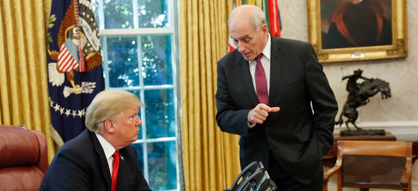 President Donald Trump listens to White House Chief of Staff John Kelly in the Oval Office in 2018.